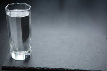 A glass with water in dark background