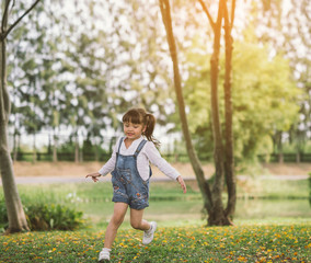 little girl playing running at nature park