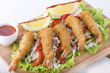 Fried Shrimps tempura with  sauce and lemon on  wooden board