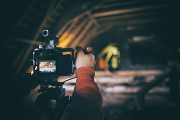 The videographer is working on the report, Camera on aluminium case