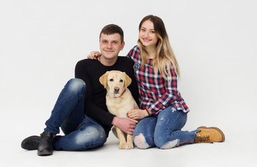 Obraz na płótnie Canvas family embraces a dog labrador