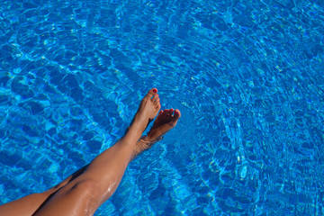 woman's feet touching water