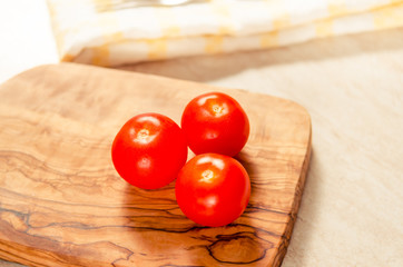 cherry tomatoes on wooden stong