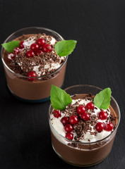 Chocolate mousse with currant and mint in a glasses