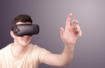 Young impressed man wearing virtual reality goggles
