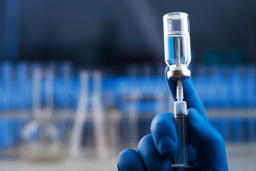 Medical hands holds syringe and vaccine