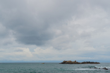 A ridge of rocks in the ocean.