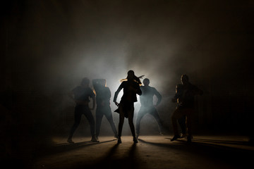a group of street dancers performing different moves on the dark street. love dancing