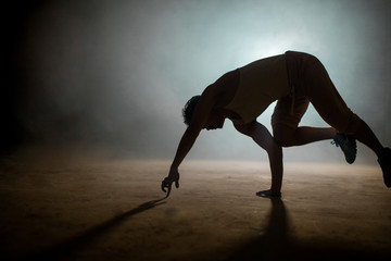 man looking for balance. connection with earth. beginning of stunt. warming up for performance