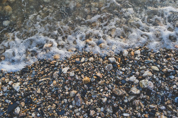 Pebble beach with sea water close up