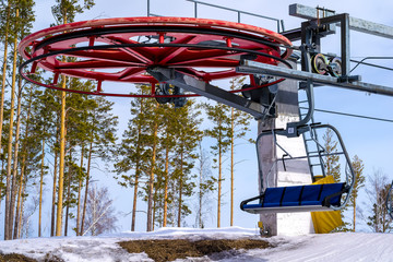 wheel mountain ski lift with chairs on top of the mountain