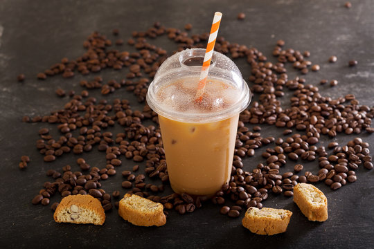 iced coffee in plastic glass with beans