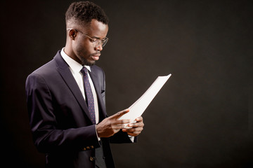 side view closeup portrait of successful unshaven worker reading papers in the office. conclusion a contract