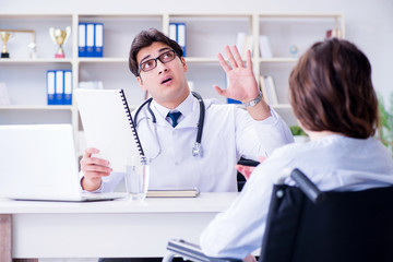 Female patient visiting male doctor for regular check-up in hosp