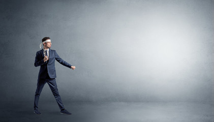 Obraz premium Small karate man fighting in an empty grey copy space