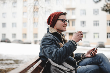 Fototapeta premium Smiling hipster man drink coffee outdoor