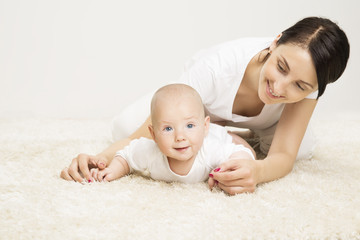 Mother and Crawling Baby, Infant Child Raised Head, Active Kid and Happy Mom Lying on Carpet