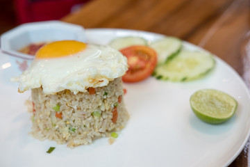 Fried rice with fried egg served on plate