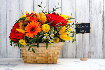 Basket with beautiful bright flowers. Mothers day greeting card