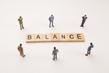businessman figures meeting on balance word