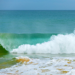 Obraz premium Foam wave, running on the sandy shore.