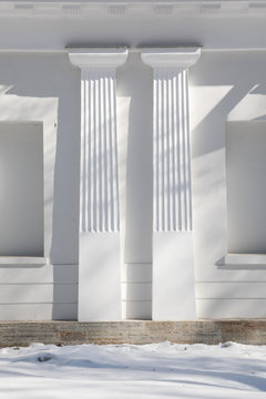 white wall with columns and snow