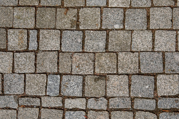 Granite cobble stone pavement background texture.