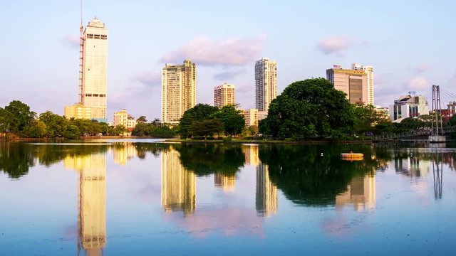 Sri Lanka. View of Beira Lake in Colombo, Sri Lanka with buddhist temple and modern buildings at sunrise. Morning time-lapse. Clear sky, zoom in