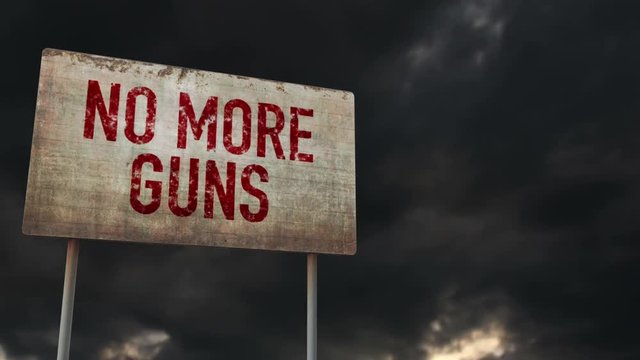 4K No More Guns Rusty Sign under Clouds Timelapse