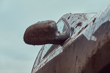 Close-up image of a dirty car after a trip around the countryside