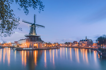 Windmill De Adriaan reflected in river Spaarne Haarlem North Holland The Netherlands Europe