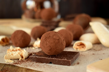 Chocolate truffles sprinkled with cocoa powder and meringues