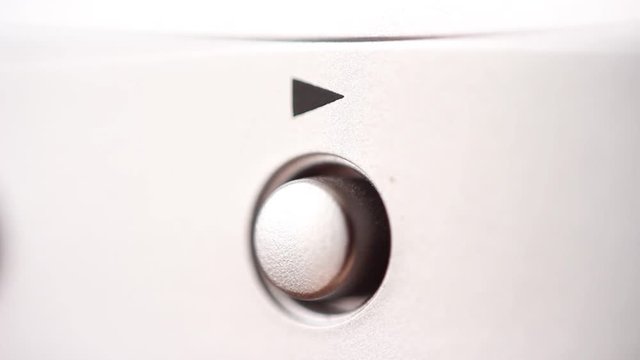 Play button on metallic device. Macro focus