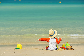 Fototapeta na wymiar Two year old toddler playing on beach