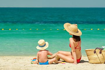 Toddler boy on beach with mother
