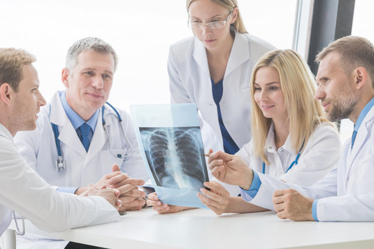 Group of doctors looking at x-ray