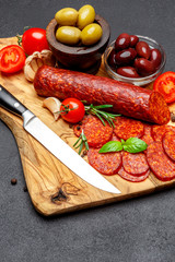 Dried organic salami sausage or chorizo on wooden cutting board