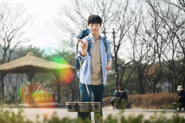 Young man traveling in Korea. Korean traditional play