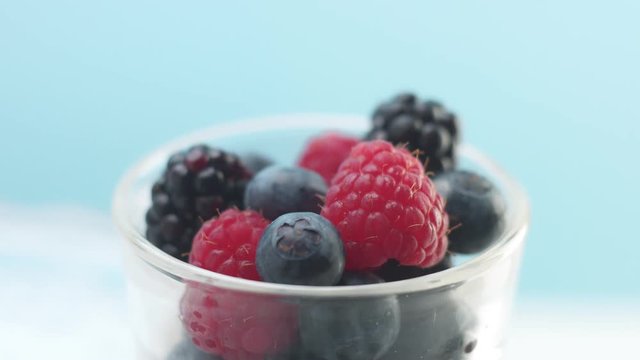 glass with yogurt or panna cotta with berries moves from blur to camera to focus Minimalism food video