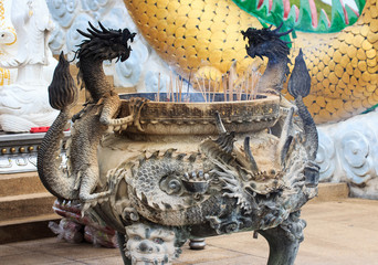 the decorative incense pot inside the Temple of Literature with detailed pattern of dragons and sacred animals