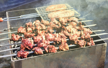 The most delicious sausages, appetizing shish kebab from fresh meat shish kebab , grilled from charcoal, outdoors