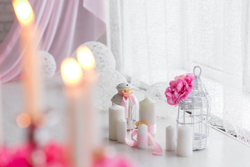 beautiful decor of white and pink. Peonies and burning candles on a light background.