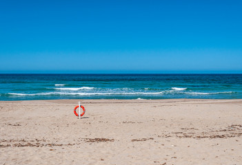 Fototapeta na wymiar lifebuoy on a deserted beach