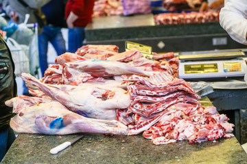 Meat seller in the market, a lot of different meat.
