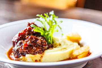 Stewed meat with onions and mashed potatoes.