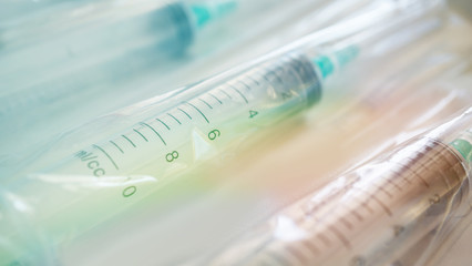 disposable plastic syringes with needles in the package. Macro shot.