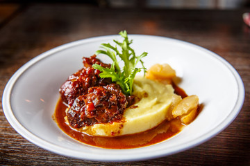 Stewed meat with onions and mashed potatoes.