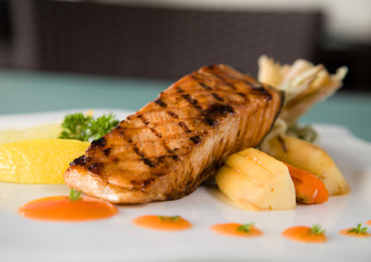 delicious grilled tuna fish portion n plate ready to serve at restaurant on white background
