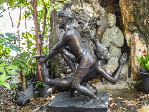 Bangkok, Thailand - Circa January 2018: Statues depicting a Thai Massage (Nuad Boran) move at the famous Wat Pho (Buddhist Temple)