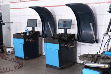 Car service center interior with modern tire fitting and wheel balancing equipment